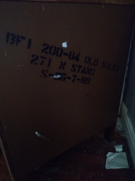 Markings on the back of a dresser.