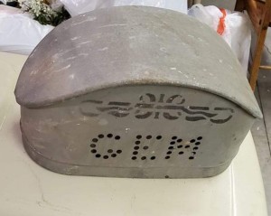 A small metal item resembling a box with the word "GEM" on the side.