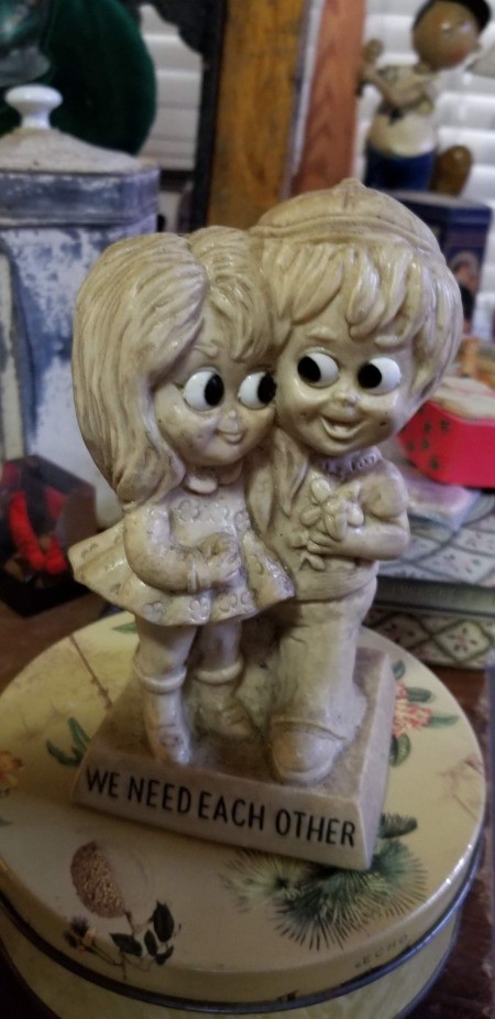 A figurine of a couple with large eyes.