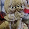 A figurine of a couple with large eyes.