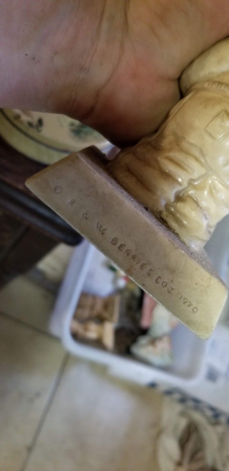 The manufacturer's marking on the back of a figurine.