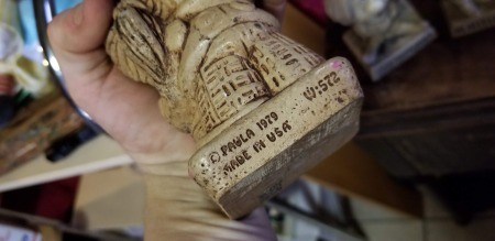 The manufacturer's marking on the back of a figurine.