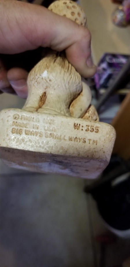 The manufacturer's marking on the back of a figurine.
