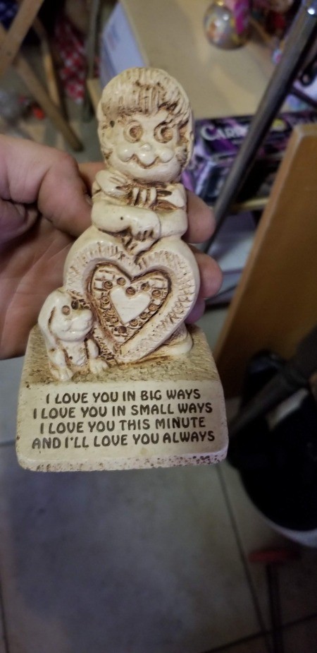 A small figurine with words inscribed below.