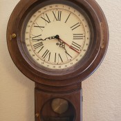 An old wall clock with a pendulum.
