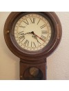 An old wall clock with a pendulum.