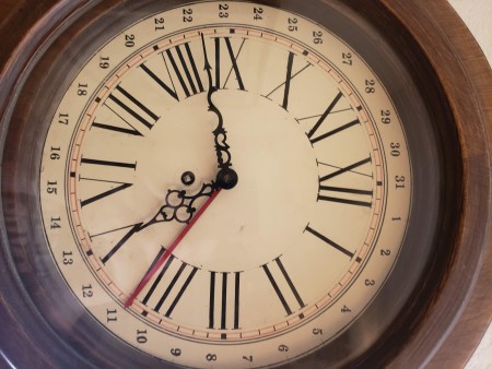 A close up of an old wall clock.