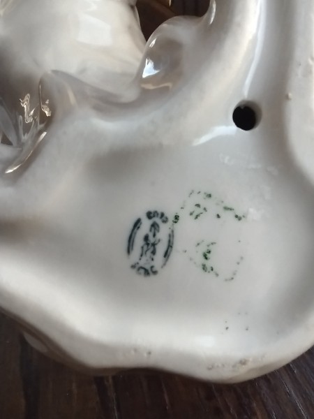 The markings on the bottom of figurine.