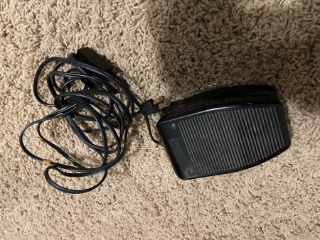 The foot pedal for a sewing machine.