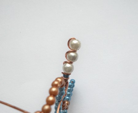 Adding wire around the beads.