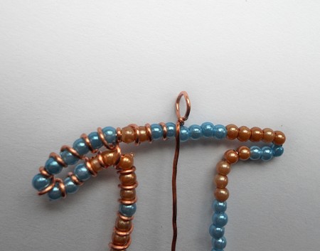 Forming a loop at the top of the pendant.