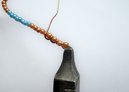Wrapping wire around the beads.