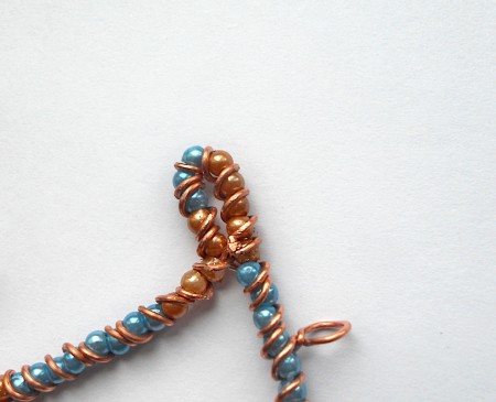 Forming the top edges of the pendant.