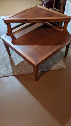 The side of an end table with a triangular shelf.