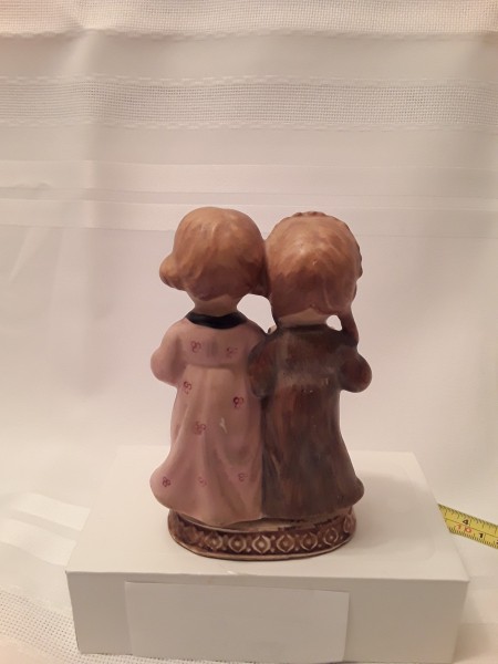 A figurine of two girls from the back.