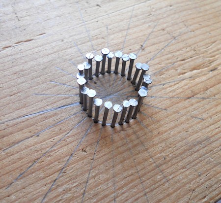 Adding nails to the circle at each ray.