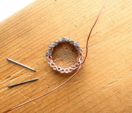 Removing half the nails to expose the woven copper.