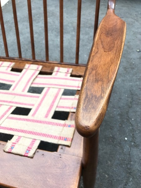 A close up of the arms of the chair.