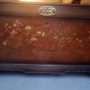 A Lane cedar chest with painted flowers.