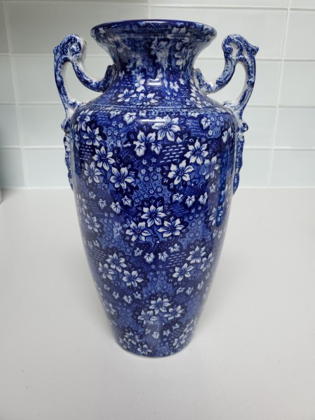 The flowered back of a blue and white vase.