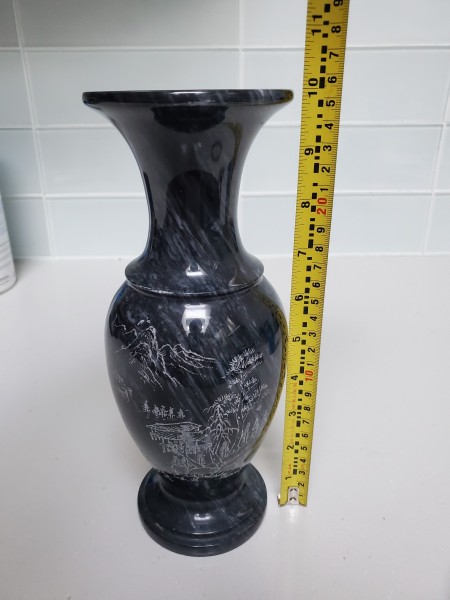 A black marble vase measuring 10 inches high.