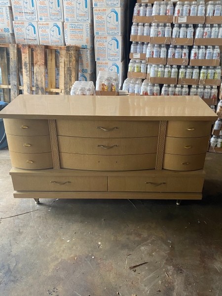 An old fashioned dresser with many drawers.