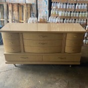 An old fashioned dresser with many drawers.