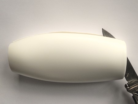 Cutting down the side of the bottle.