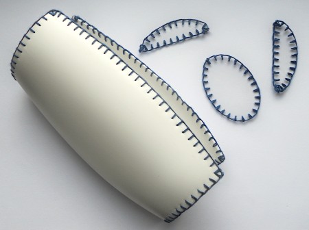 All the plastic pieces edged in blue thread.