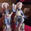 Two old fashioned figurines of a young man and woman.