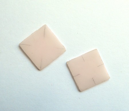 Two square pieces of plastic.
