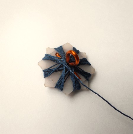 Wrapping thread around the star shape.