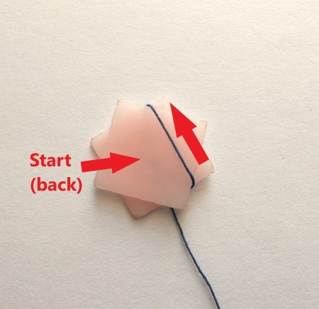 Wrapping thread around the star shape.