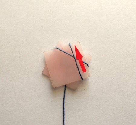 Wrapping thread around the star shape.