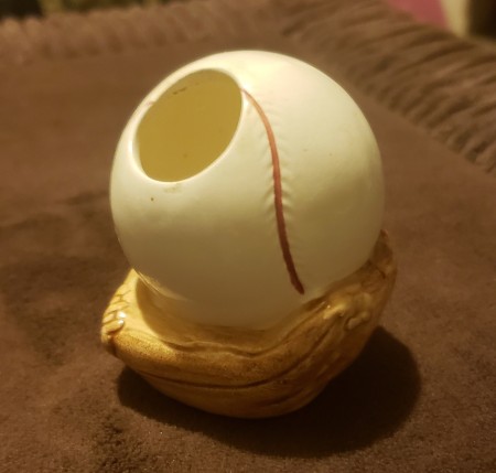 A ceramic baseball and glove figurine.