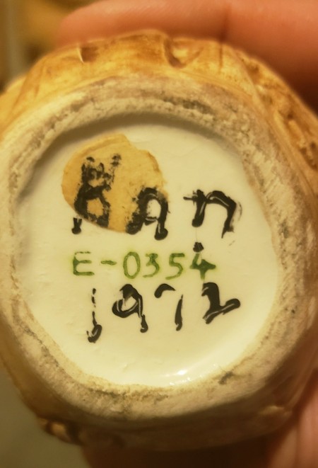 The markings on the back of the figurine.
