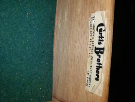 A Curtis Brothers label on the back of a dresser.