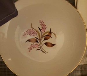 A china plate with a decorative pattern in the middle.