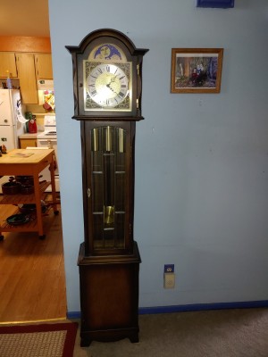 A wooden grandfather clock in a home.