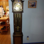 A wooden grandfather clock in a home.