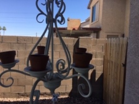 A chandelier with terra cotta pots.