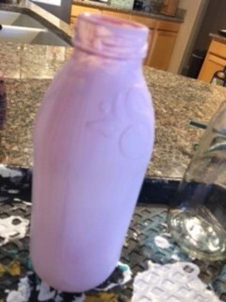 Painting recycled bottles with paint.