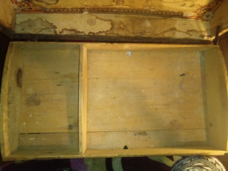 The inside of an old wooden chest.