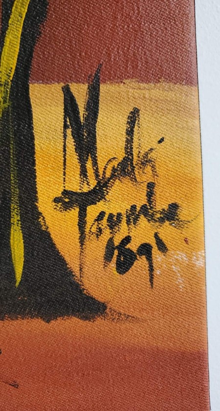 A signature on a canvas painting.