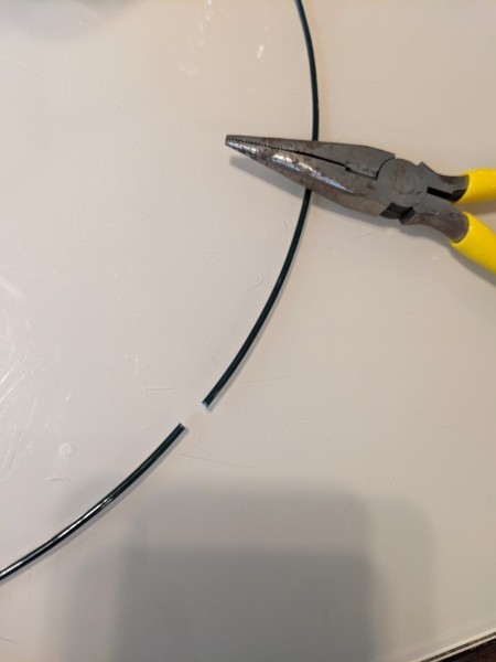 Cutting the wire with pliers.