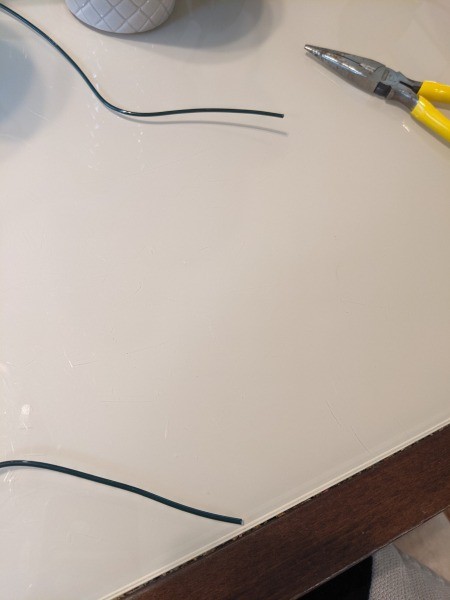 Bending the wire with pliers.