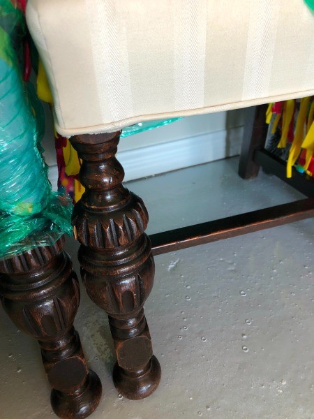 The legs of fabric covered dining chairs.