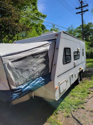 A travel trailer parked in a yard.