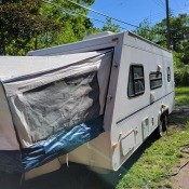 A travel trailer parked in a yard.