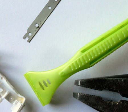 Removing the blade from a box cutter.